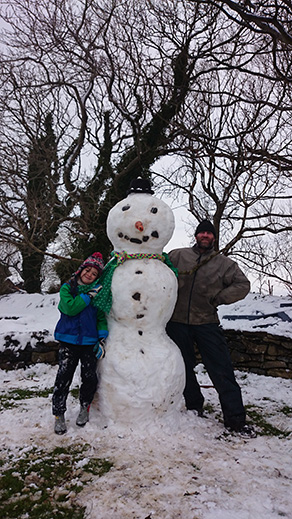 snowman at the mud and wood house